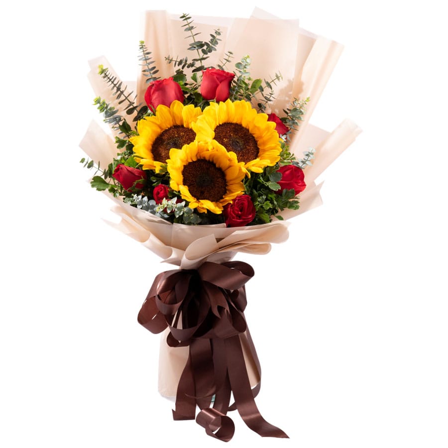 A bouquet of vibrant red roses, cheerful sunflowers, and fragrant eucalyptus baby blue, wrapped with beige and brown paper and tied with a ribbon.