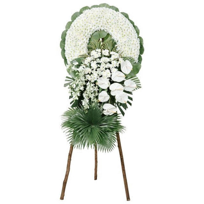 Round condolence flower arrangement featuring Radus, Anthurium, and Orchid flowers, accented with Anahaw, Fishtail, Korean, and Ducktail leaves. This beautiful, circular display expresses heartfelt sympathy.